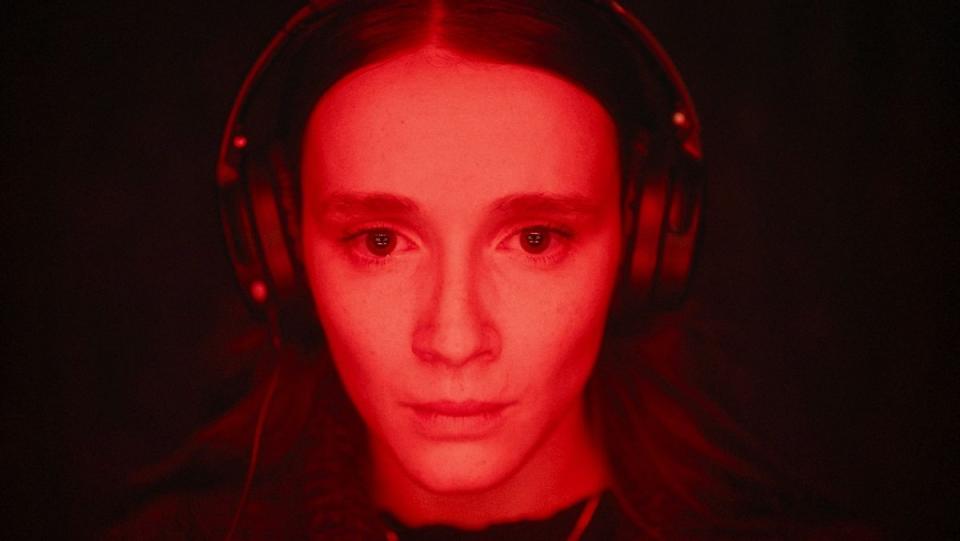 A girl wears headphones in Red Rooms at the Fantasia International Film Festival.