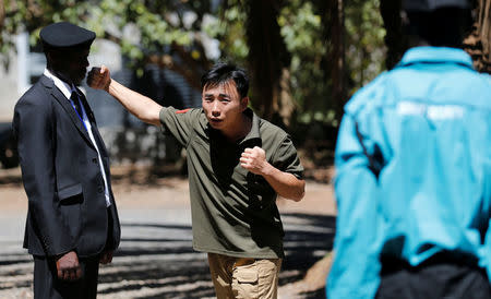 Chinese national Jack Wang, a security trainer at the Chinese-run Deway Security Group leads a Kenyan security guard in martial arts combat training at their company compound in Kenya's capital Nairobi, March 13, 2017. REUTERS/Thomas Mukoya