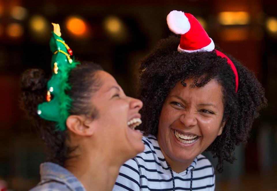 File photo from November 2018 shows Rose Berberena of South Carolina, left, in the holiday spirit as she shopped with her sister Liliana Berberena of Homestead during Black Friday shopping weekend that year at the Dolphin Mall in the Doral area. PATRICK FARRELL/pfarrell@miamiherald.com