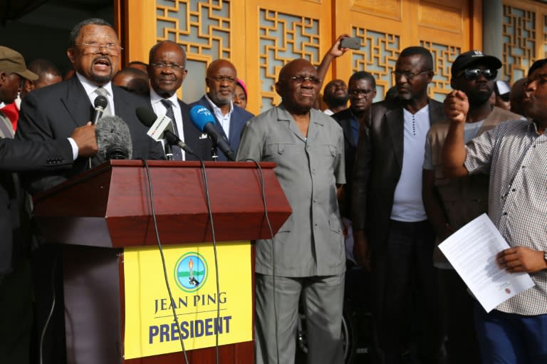 Gabonese opposition leader Jean Ping (L) flanked by opponents Casimir Oye Mba (2L) and Zacharie Myboto (C) speaks to supporters during a press conference in Libreville