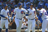 Chicago Cubs' Ian Happ, second from left, is congratulated by teammate Willson Contreras (40) after hitting a three-run home run during the first inning of a baseball game against the Cincinnati Reds, Monday, Sept. 6, 2021, in Chicago. (AP Photo/Matt Marton)