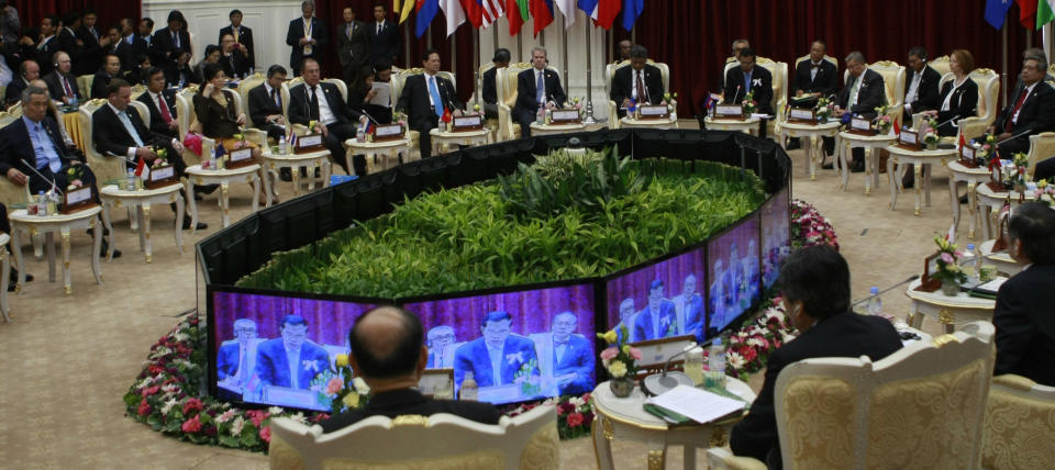 Delegates listen and watch as Cambodian Prime Minister Hun Sen, shown on the monitor screens, delivers an opening speech during the ASEAN Global Dialogue in Phnom Penh, Cambodia Tuesday, Nov. 20, 2012. (AP Photo/Apichart Weerawong)