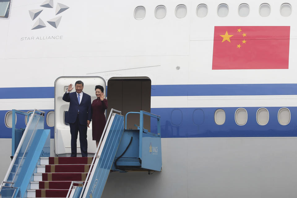 Chinese President Xi Jinping, left, and his wife Peng Liyuan, right, wave as they arrive at Noi Bai International airport in Hanoi, Vietnam, Tuesday, Dec. 12, 2023. Chinese leader Xi arrived in Vietnam on Tuesday seeking to further deepen ties with the Southeast Asian nation, weeks after it elevated its diplomatic relations with Western-aligned countries. (Luong Thai Linh/Pool Photo via AP)