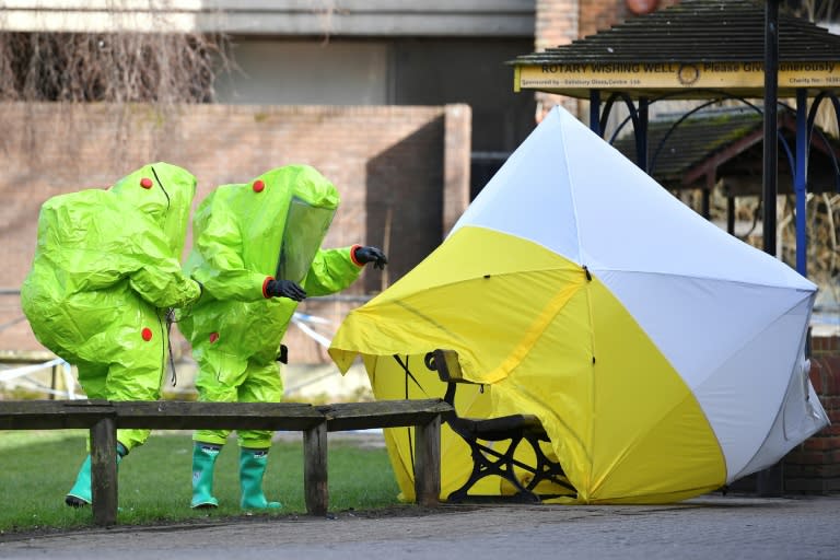 Members of the emergency services in green biohazard suits afix the tent over the bench where Sergei Skripal and his daughter Yulia were found on March 4 in critical condition in Salisbury