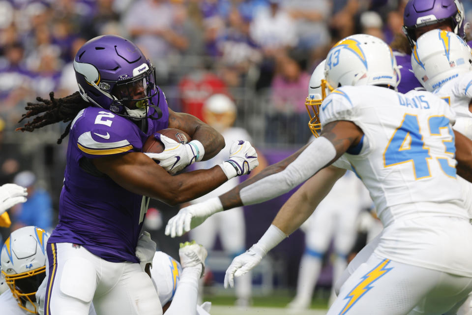 Minnesota Vikings running back Alexander Mattison (2) runs from Los Angeles Chargers cornerback Michael Davis (43) during the first half of an NFL football game, Sunday, Sept. 24, 2023, in Minneapolis. (AP Photo/Bruce Kluckhohn)