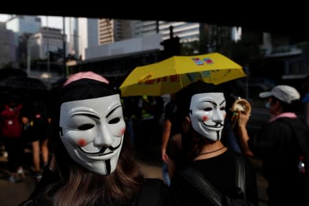 Anti-government protesters wearing masks attend a protest in central Hong Kong