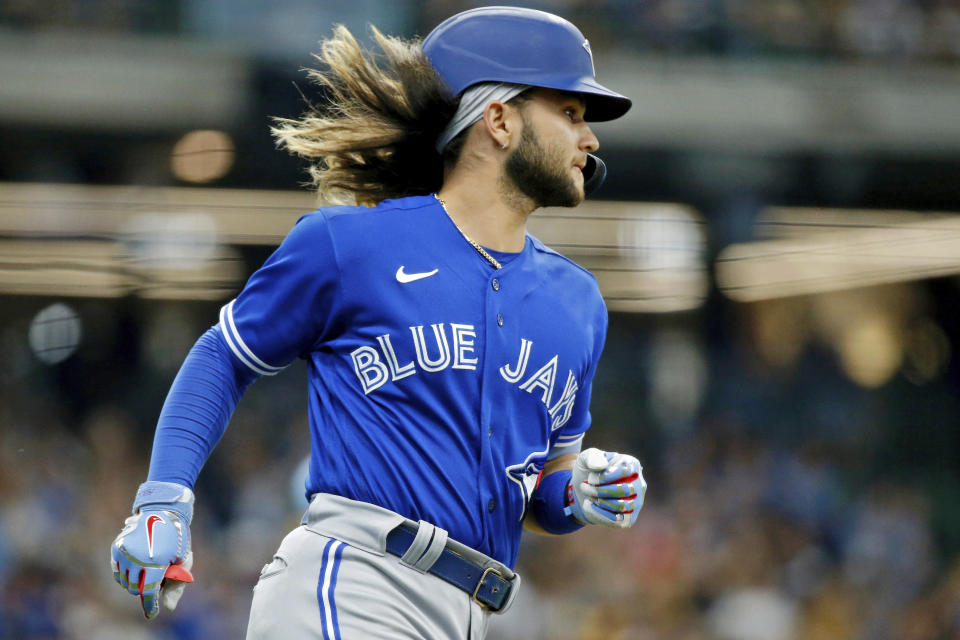 FILE - Toronto Blue Jays' Bo Bichette rounds the bases after hitting a solo home run against the Milwaukee Brewers during the eighth inning of a baseball game, Saturday, June 25, 2022, in Milwaukee. In all, more than two dozen major league offspring are on AL or NL rosters this year. The Blue Jays alone have three, including the sons of Hall of Famers Craig Biggio (Cavan) and Vladimir Guerrero (Vlad Jr.), along with Bo Bichette, whose father, Dante, was a four-time All-Star with the Rockies.(AP Photo/Jon Durr, File)