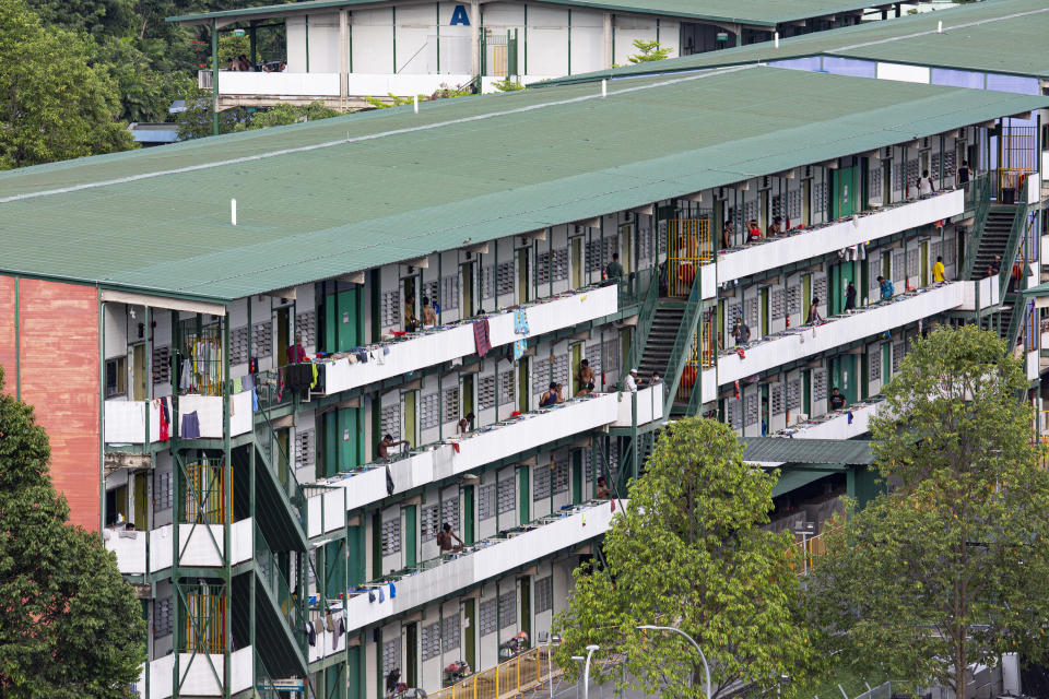 SINGAPORE, SINGAPORE - APRIL 18: Migrant workers can be seen in the Cochrane Lodge II, a purpose-built migrant workers dormitory that has been gazetted as an isolation area on April 18, 2020 in Singapore. (Photo by Ore Huiying/Getty Images)
