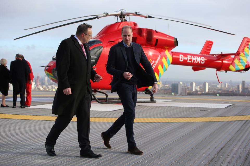 Britain's Prince William, Duke of Cambridge (R), walks across the helipad after arriving in a red London Air Ambulance at the Royal London Hospital in east London on January 9, 2019. - The Duke of Cambridge visited London's Air Ambulance to recognise the work that the organisation's first responders carry out delivering life-saving treatment across London. (Photo by Ian Vogler / POOL / AFP)        (Photo credit should read IAN VOGLER/AFP/Getty Images)