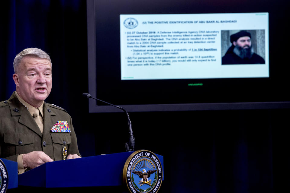 Positive identification information on Abu Bakr al-Baghdadi is displayed as U.S. Central Command Commander Marine Gen. Kenneth McKenzie speaks, Wednesday, Oct. 30, 2019, at a joint press briefing at the Pentagon in Washington. (AP Photo/Andrew Harnik)