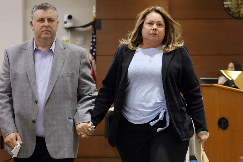 Tony and Jennifer Montalto walk hand-in-hand from the witness stand after Jennifer gave her victim impact statement during the penalty phase of the trial of Marjory Stoneman Douglas High School shooter Nikolas Cruz at the Broward County Courthouse in Fort Lauderdale, Fla., Wednesday, Aug. 3, 2022. The Montalto's daughter, Gina, was killed in the 2018 shootings. Cruz previously plead guilty to all 17 counts of premeditated murder and 17 counts of attempted murder in the 2018 shootings. (Amy Beth Bennett/South Florida Sun Sentinel via AP, Pool)