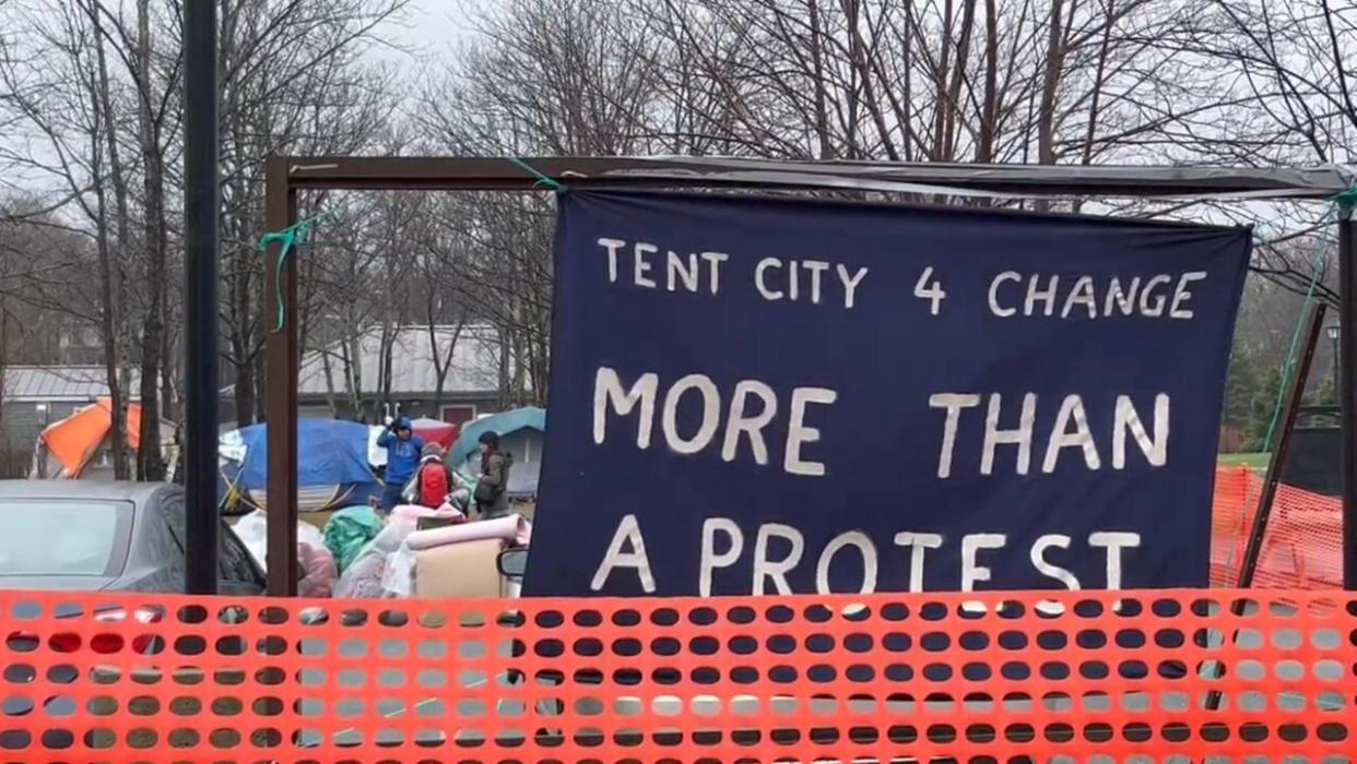 Police and government workers moved in on tents around the Colonial Building near Bannerman Park on Friday, clearing an encampment that had been there for months. (Henrike Wilhelm/CBC - image credit)