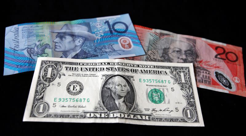 FILE PHOTO: A US dollar note is pictured alongside Australian dollars in this picture illustration taken in Washington