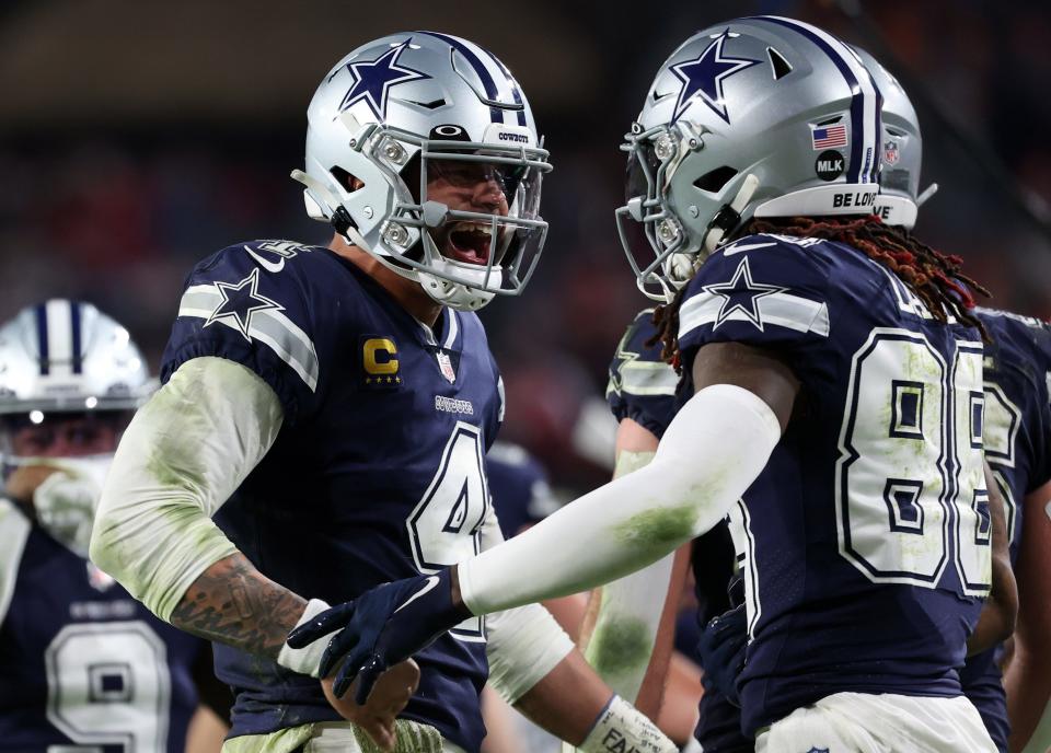 Dallas Cowboys quarterback Dak Prescott (4) reacts with wide receiver CeeDee Lamb (88) after throwing a touchdown pass.