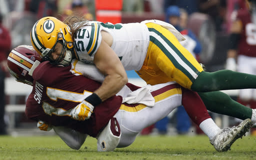 Green Bay Packers linebacker Clay Matthews (52) hits Washington Redskins quarterback Alex Smith (11). (AP Photo/Alex Brandon)