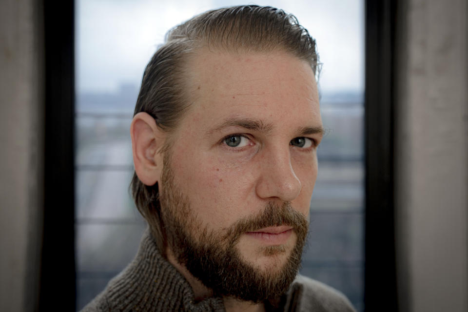 Steve Caccamo, a former student at the Academy at Ivy Ridge, poses for a photo in his apartment, Thursday, March 28, 2024, in New York. A Netflix docuseries spotlighting abuse allegations at the long-shuttered Academy at Ivy Ridge in rural northern New York has prompted dozens of new complaints to the local prosecutor and a fresh investigation. (AP Photo/Peter K. Afriyie)