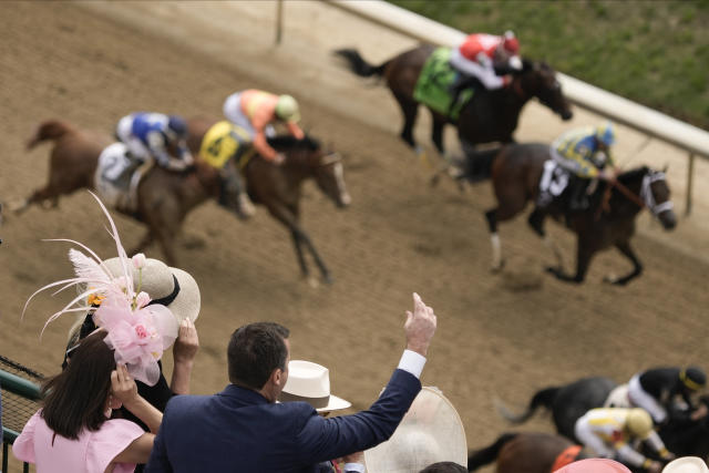 People react as they watch a horse race at Churchill Downs Saturday, May 6, 2023, in Louisville, Ky. (AP Photo/Charlie Riedel)