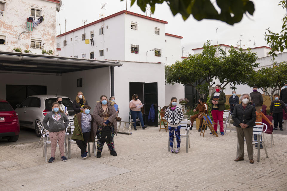 Catholic worshipers keep social distance guidelines during a religious event outside Nuestra Senora de la Candelaria church in Seville, southern Spain, Friday, Feb. 26, 2021. Few Catholics in devout southern Spain would have imagined an April without the pomp and ceremony of Holy Week processions. With the coronavirus pandemic unremitting, they will miss them for a second year. (AP Photo/Laura Leon)