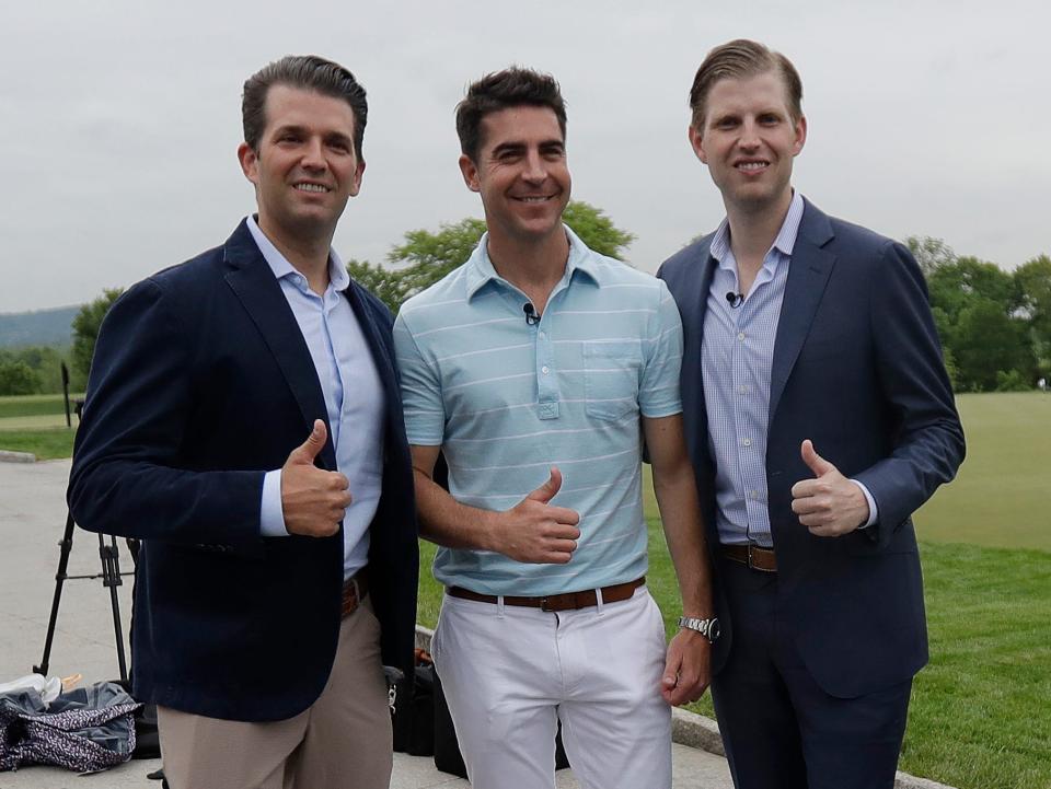 Jesse Watters stands between Donald Trump Jr. and Eric Trump.