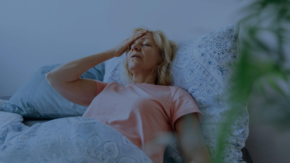 A woman in bed suffering from night sweats