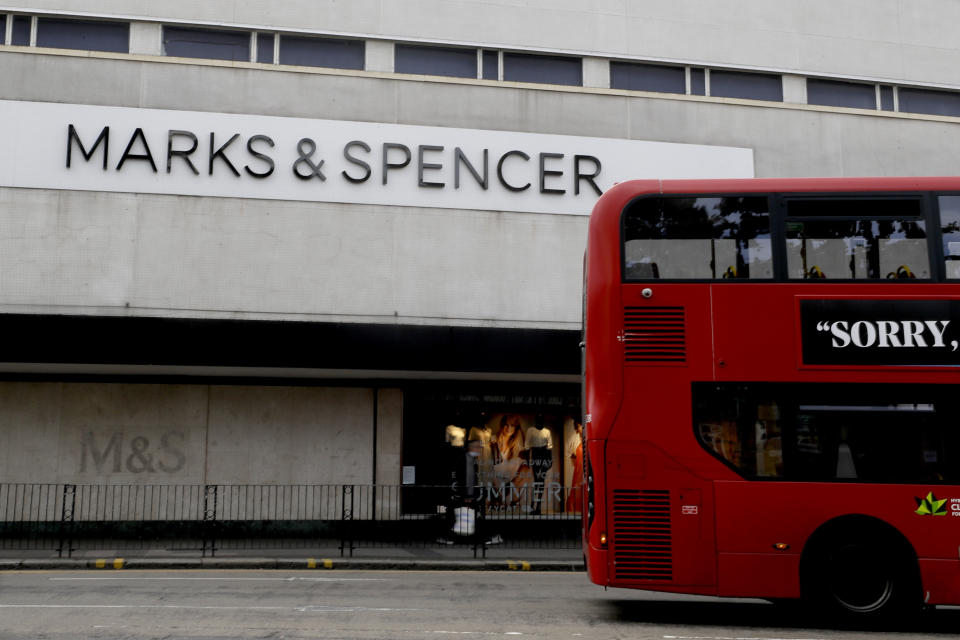 A bus passes a branch of Marks and Spencer in London, Tuesday, Aug. 18, 2020. Marks and Spencer has said it will cut 7,000 jobs over the next three months as the UK retailer overhauls its business in the latest sign of how the coronavirus pandemic has disrupted the high street. (AP Photo/Kirsty Wigglesworth)