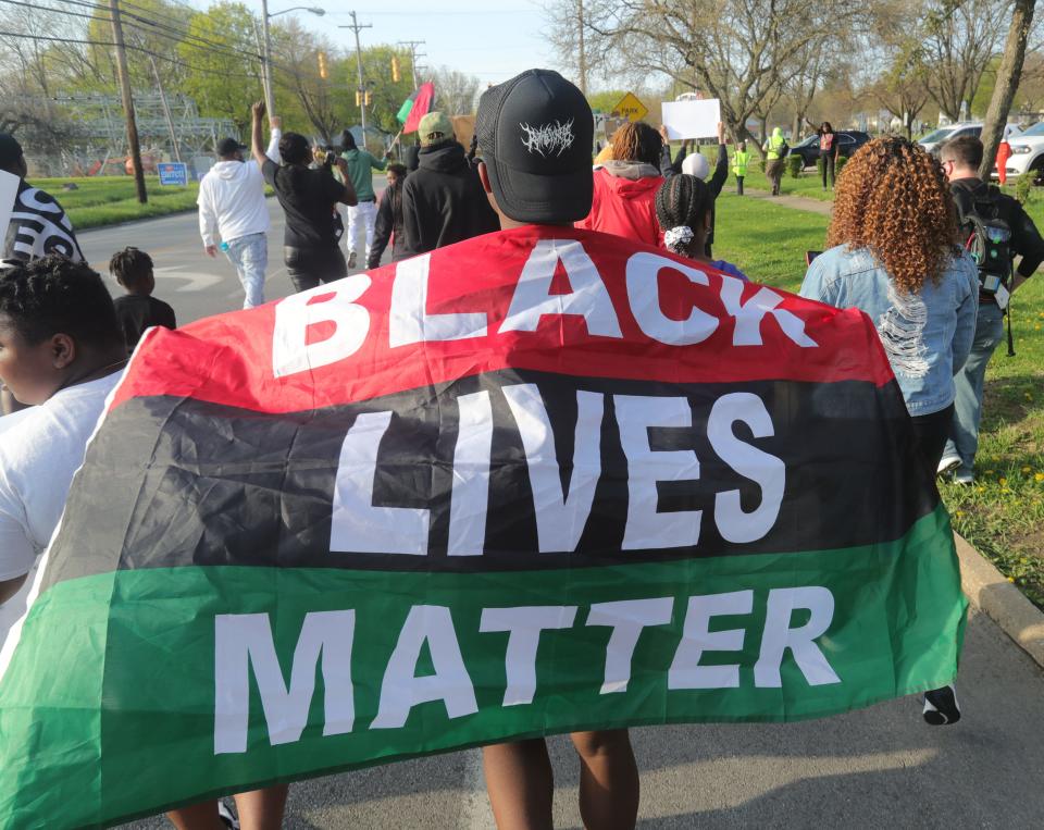 A protester walks on South Hawkins Avenue during a protest on April 19 in the Copley Road area in Akron.