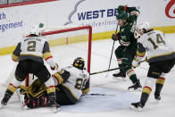 Minnesota Wild left wing Kirill Kaprizov (97) scores a goal on Vegas Golden Knights goaltender Marc-Andre Fleury (29) with Golden Knights defensemen Zach Whitecloud (2) and Nicolas Hague (14) defending during the third period during an NHL hockey game Wednesday, May 5, 2021, in St. Paul, Minn. The Golden Knights won 3-2 in overtime. (AP Photo/Andy Clayton-King)