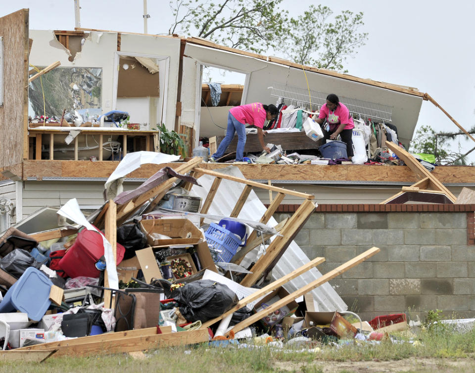 Skyla Hall, left, and Courtney Thornton search for belongings near Thornton's aunt's home where severe storms destroyed a trailer park in rural Lee County near Crawford, Ala., Tuesday, April 29, 2014. (AP Photo/AL.com, Julie Bennett)