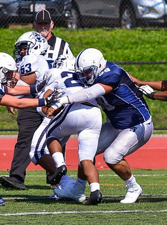 Somerset Berkley’s Eric Raad tackles Lawrence’s Elijah Santell during a recent game at Somerset Berkley.