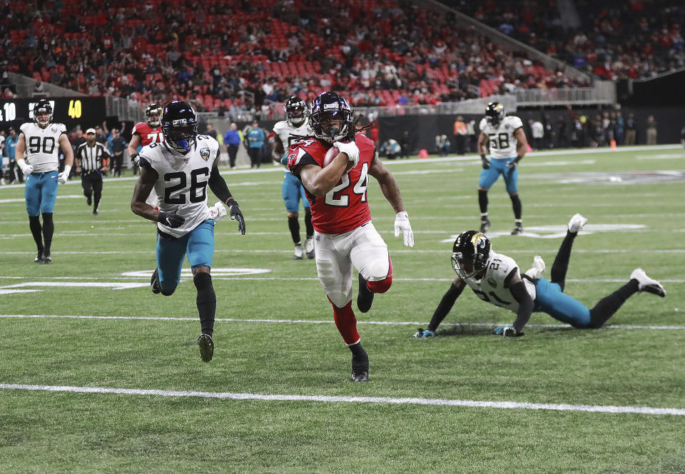 Atlanta Falcons running back Devonta Freeman (24) breaks free for a touchdown run on the opening drive against the Jacksonville Jaguars during the first quarter of an NFL football game Sunday, Dec. 22, 2019, in Atlanta. (Curtis Compton/Atlanta Journal-Constitution via AP)