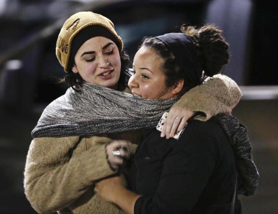 Women react after being released from the Garden State Plaza mall after police initiated a lockdown following reports of gunshots in the mall in Paramus