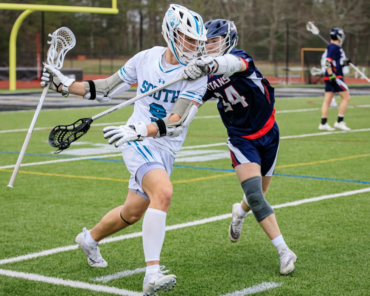 Plymouth South's Holden Lassige guards the ball as he tries to escape the defense of Pembroke's Brendan Kanya.