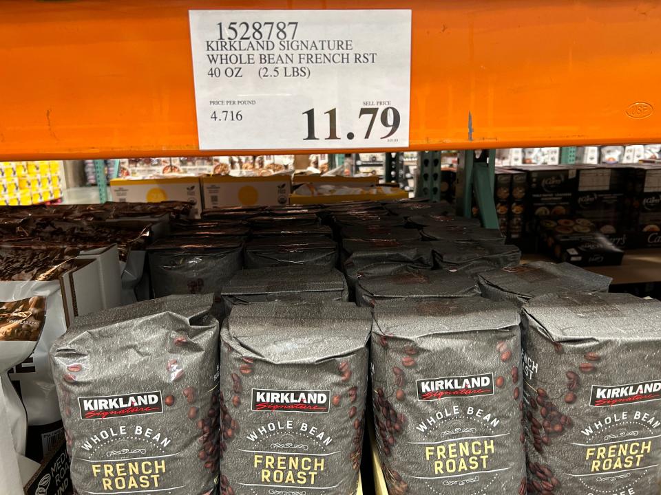Kirkland coffee display with $11.79 price sign on it on an orange beam at Costco