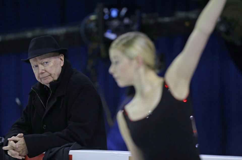 FILE - Frank Carroll, coach of figure skater Gracie Gold, keeps an eye on the skater as she practices at the Skate America figure skating competition Friday, Oct. 23, 2015, in Milwaukee. Longtime figure skating coach Frank Carroll, who over the course of a 60-year career helped guide six Olympic medalists at 10 Winter Games, including Michelle Kwan and Evan Lysacek, died Sunday, June 9, 2024. He was 85.(AP Photo/Jeffrey Phelps, File)