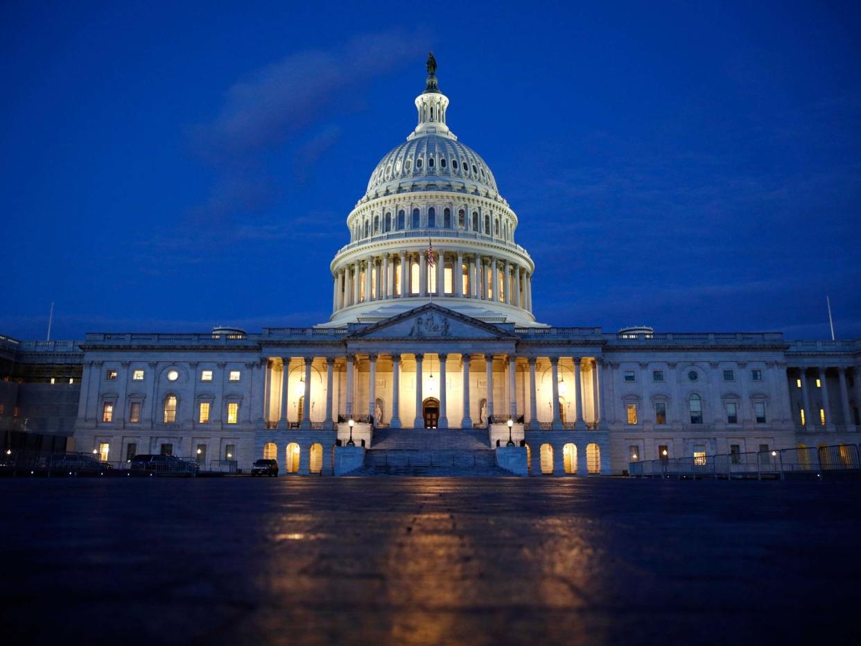 Light shines on the US Capitol dome in Washington, early Wednesday 4 December: AP