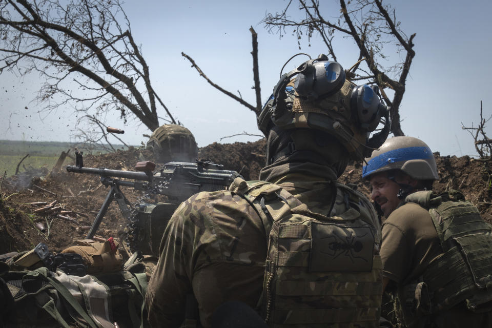 FILE - Ukrainian soldiers fire toward Russian position from a trench on the frontline in Zaporizhzhia region, Ukraine, Friday, June 23, 2023. Battles are also raging along the southern front in Zaporizhzhia, where Ukrainian forces are making minimal gains and coming up against formidable Russian fortifications. (AP Photo/Efrem Lukatsky, File)