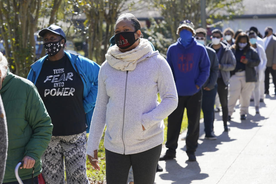 FILE - In this Nov. 3, 2020, file photo, voters standing in line at Precinct 36 as they wait to vote in the general election in Jackson, Miss. Months of discussions about racial justice are being followed by change at the ballot box. (AP Photo/Rogelio V. Solis, File)