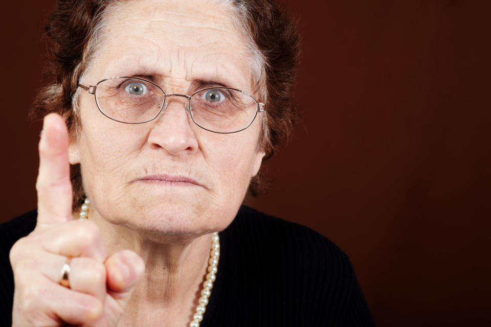 up close of a mean teacher wagging her finger