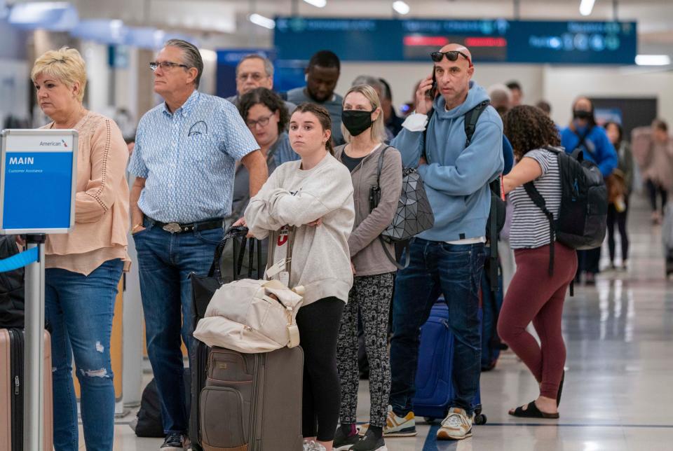 Passengers wait in line at Palm Beach International Airport in West Palm Beach, Florida on January 11, 2023. Thousands of flight delays and cancellations rippled across the U.S. after a computer outage led to a grounding order by the Federal Aviation Administration. 