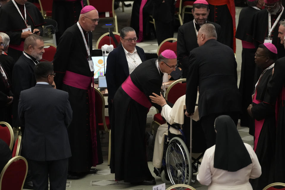 Pope Francis is greeted by the participants into the opening session of the 16th General Assembly of the Synod of Bishops as he arrives in the Paul VI Hall at The Vatican, Wednesday, Oct. 4, 2023. Pope Francis is convening a global gathering of bishops and laypeople to discuss the future of the Catholic Church, including some hot-button issues that have previously been considered off the table for discussion. Key agenda items include women's role in the church, welcoming LGBTQ+ Catholics, and how bishops exercise authority. For the first time, women and laypeople can vote on specific proposals alongside bishops. (AP Photo/Gregorio Borgia)