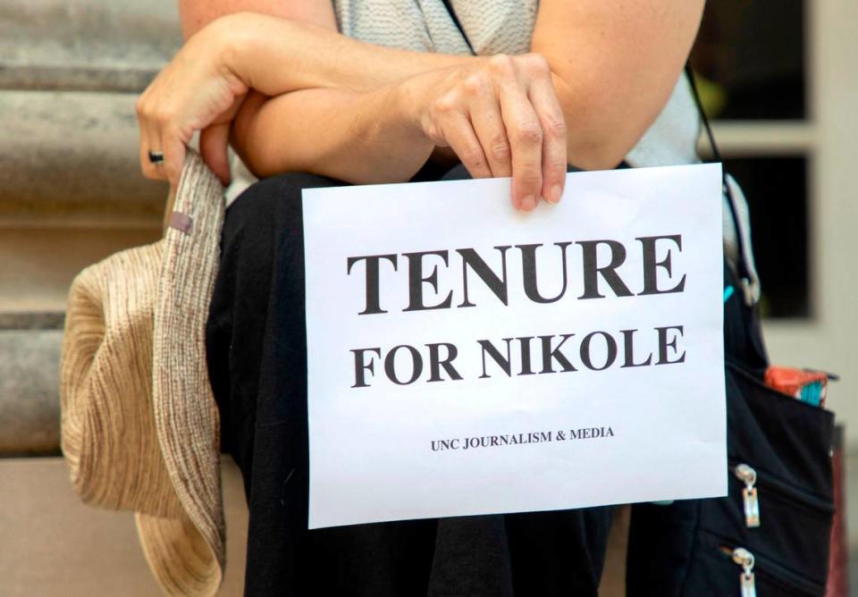 Deborah Dwyer, a doctoral candidate, holds a sign while gathered with fellow students and alumni on the steps of Carroll Hall, where the UNC-Chapel Hill Hussman School of Journalism and Media is located, before the university’s Board of Trustees is scheduled to vote on tenure for Nikole Hannah-Jones on Wednesday, Jun. 30, 2021, in Chapel Hill, N.C.