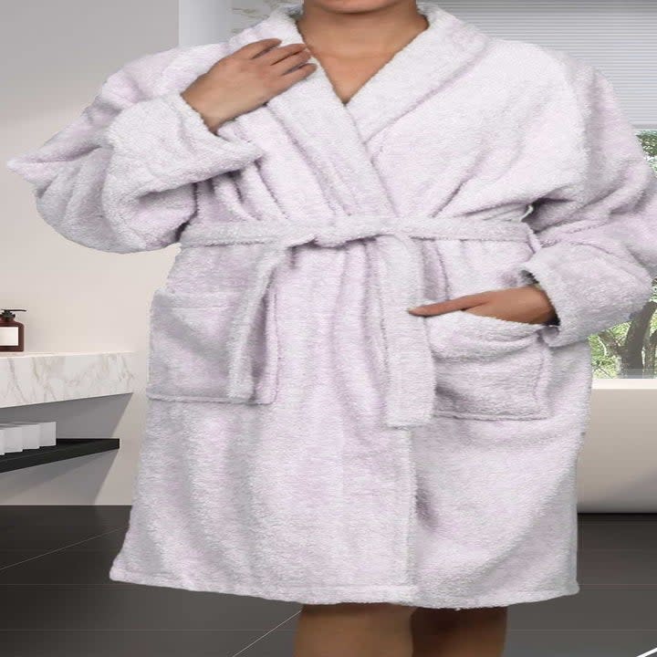a model wearing the light pink robe
