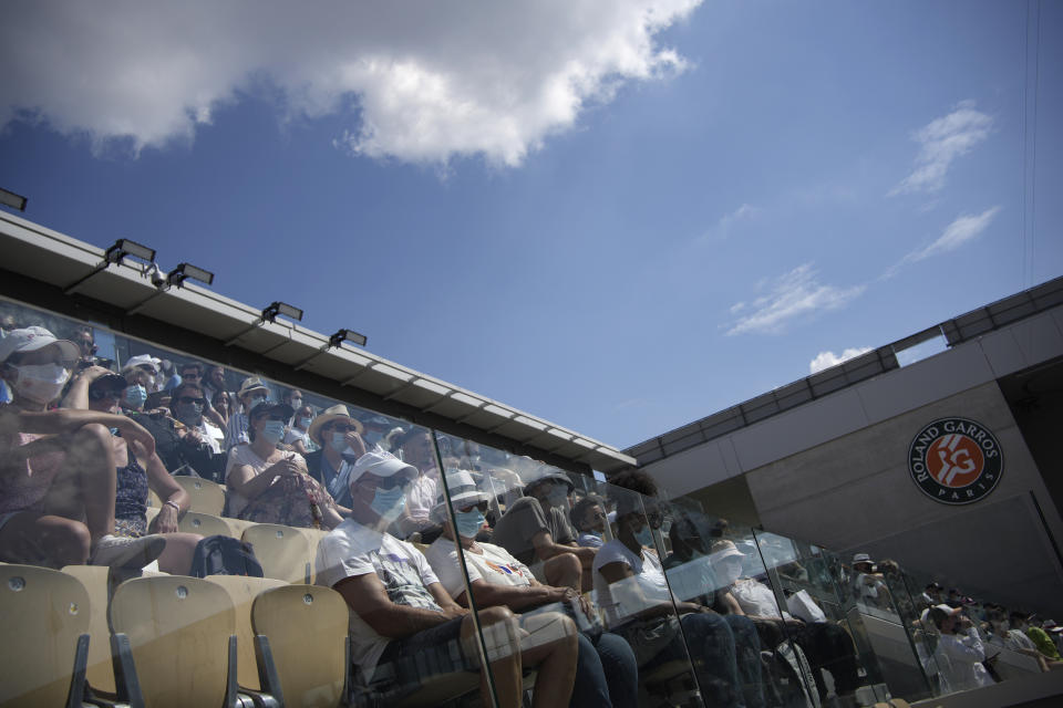 Spectators watch Slovenia's Tamara Zidansek playing Russia's Anastasia Pavlyuchenkova during their semifinal match of the French Open tennis tournament at the Roland Garros stadium Thursday, June 10, 2021 in Paris. (AP Photo/Christophe Ena)