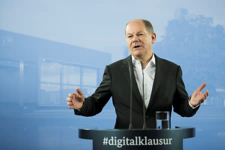 FILE PHOTO: German Finance Minister Olaf Scholz attends a press conference after a federal cabinet meeting in Potsdam, Germany November 15, 2018. REUTERS/Axel Schmidt/File Photo