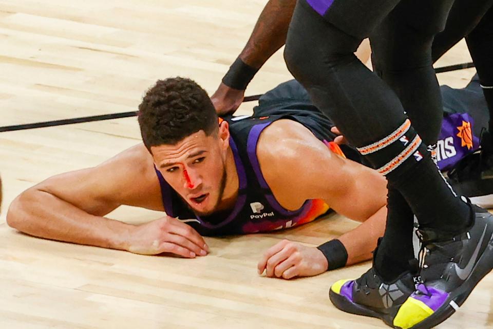 Devin Booker suffered a bloody nose after a third-quarter collision with Patrick Beverley.