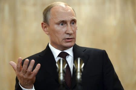 Russia's President Vladimir Putin gestures as he speaks during a news conference after the Asia-Europe Meeting (ASEM) in Milan, October 17, 2014. REUTERS/Vasily Maximov/Pool