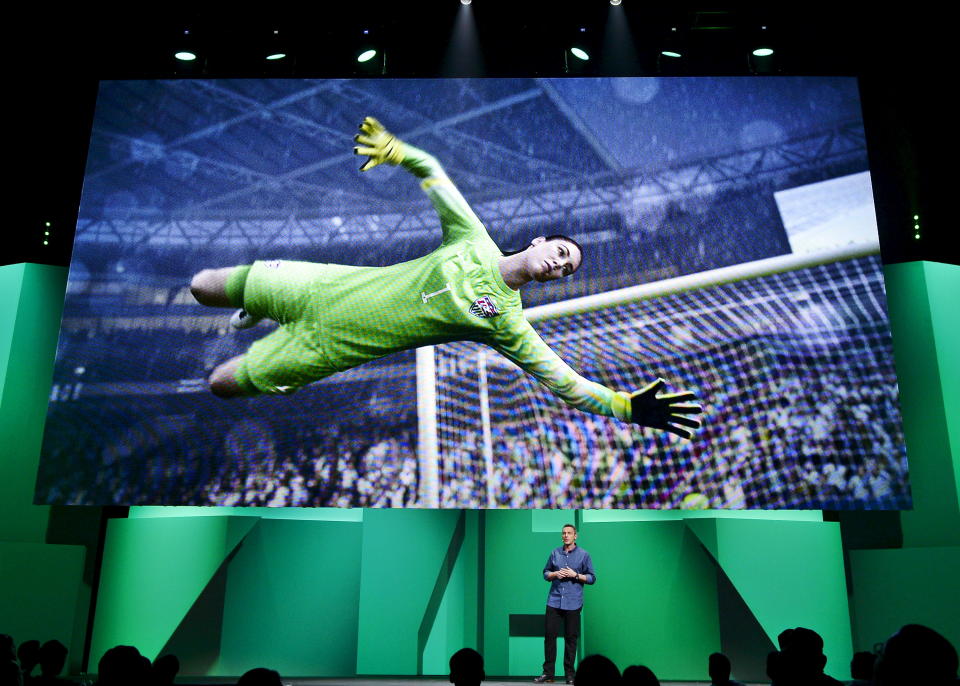 United State national soccer team's goalkeeper Hope Solo's image is shown on the screen as David Rutter, vice president and general manager of EA Sports FIFA, introduces the video game "FIFA 16" during Electronic Arts media briefing before the opening day of the Electronic Entertainment Expo, or E3, at the Shrine Auditorium in Los Angeles, California June 15, 2015.   REUTERS/Kevork Djansezian