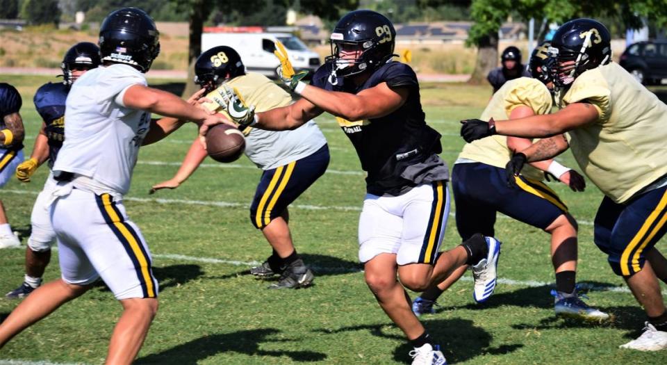 Merced College sophomore Samari Russo rushes the quarterback during practice at Merced College on Wednesday, Aug. 30, 2023.