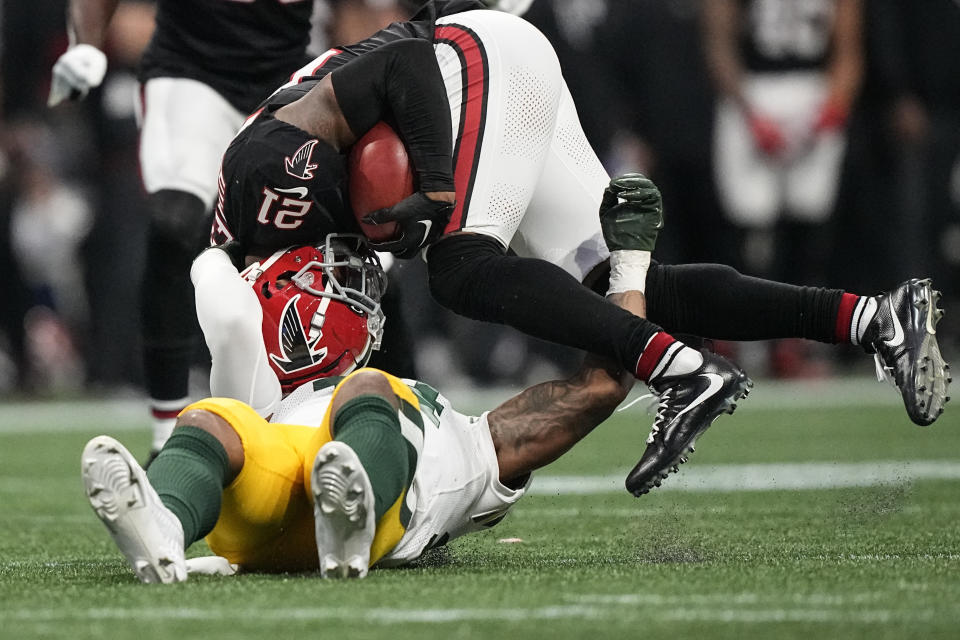 Atlanta Falcons cornerback Mike Hughes (21) is hit by Green Bay Packers safety Jonathan Owens (34) during the second half of an NFL football game, Sunday, Sept. 17, 2023, in Atlanta. (AP Photo/Brynn Anderson)