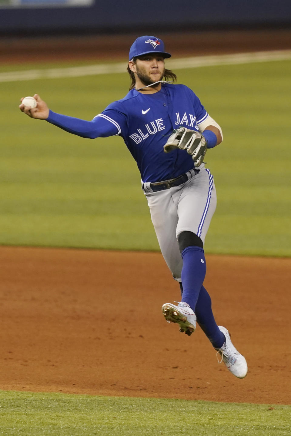 Toronto Blue Jays shortstop Bo Bichette (11) throws to first base on a hit by Miami Marlins' Starling Marte during the ninth inning of a baseball game, Tuesday, June 22, 2021, in Miami. The Blue Jays defeated the Marlins 2-1. (AP Photo/Marta Lavandier)